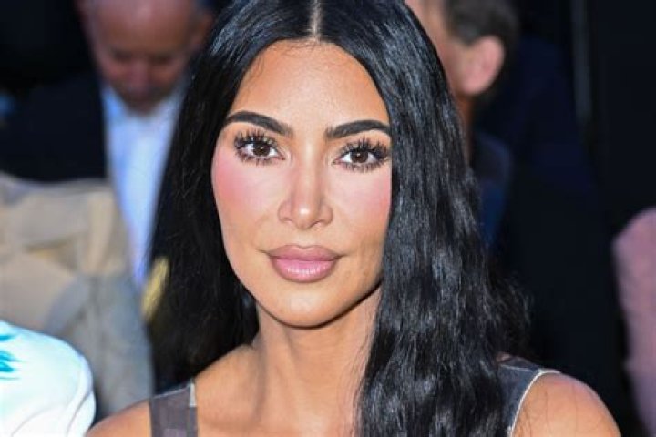 Kim Kardashian flaunts figure in cheeky black bikini during beach