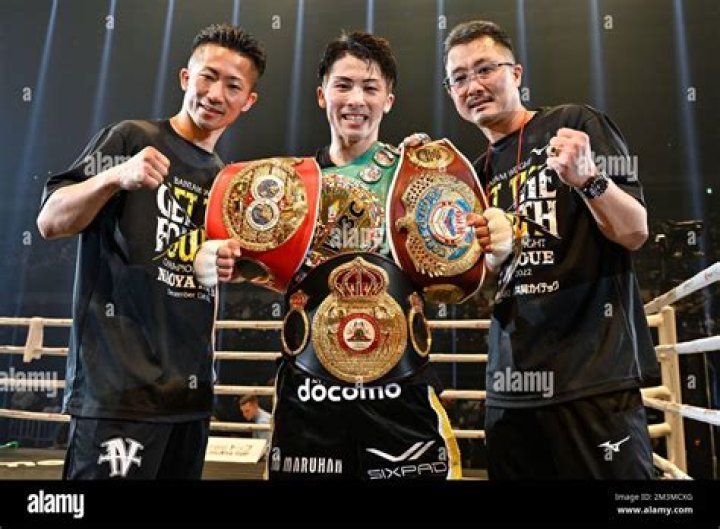 Naoya Inoue (C) of Japan celebrates with his brother Takuma Inoue (L