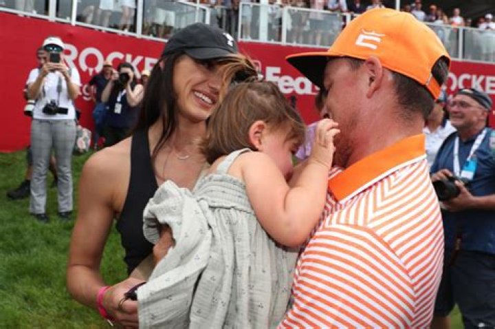 Rickie Fowler embraces wife Allison Stokke after Rocket Mortgage Classic