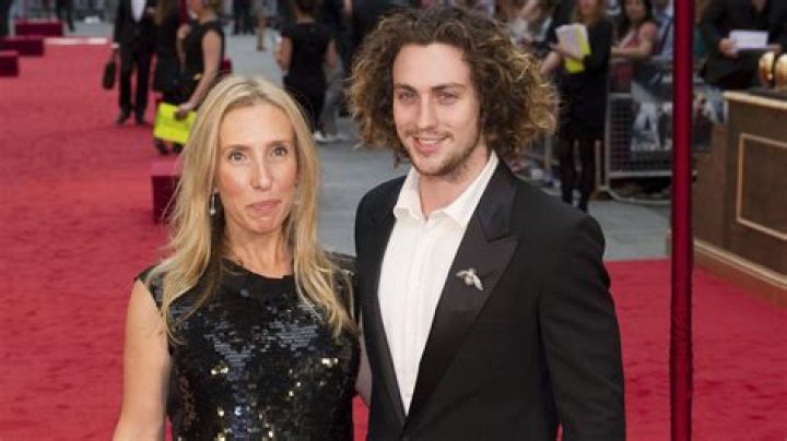 Sam TaylorJohnson, 52, and husband Aaron, 28, wear matching neutral