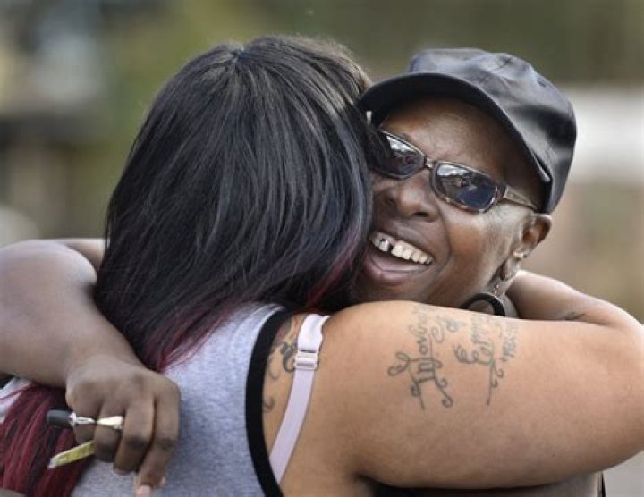 Velma Aiken, the paternal grandmother of Kamiyah, gets a congratulatory hug from a family member on Friday